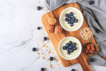 Yogurt with fresh blueberries on wooden background. Health concept.