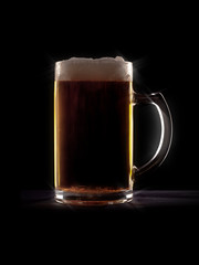 typical beer in a glass with black background