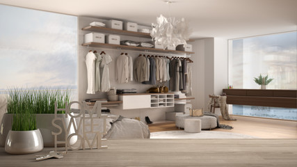 Wooden table, desk or shelf with potted grass plant, house keys and 3D letters home sweet home, over minimalist bedroom with bed, architecture interior design, copy space background