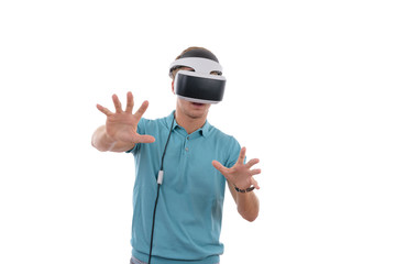 Caucasian young boy playing with virtual reality glasses dressed in a blue polo shirt isolated in white background