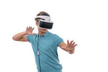 Caucasian young boy playing with virtual reality glasses dressed in a blue polo shirt isolated in white background