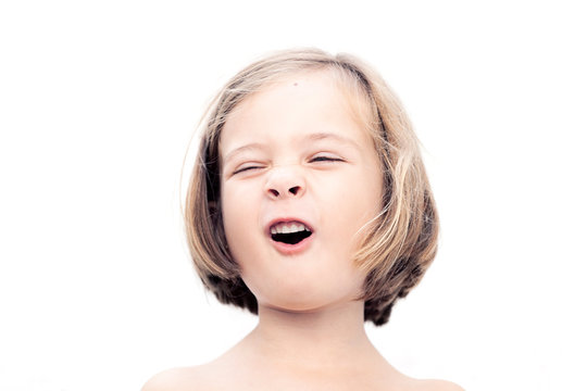 a happy smiling 5 years girl againt a white background