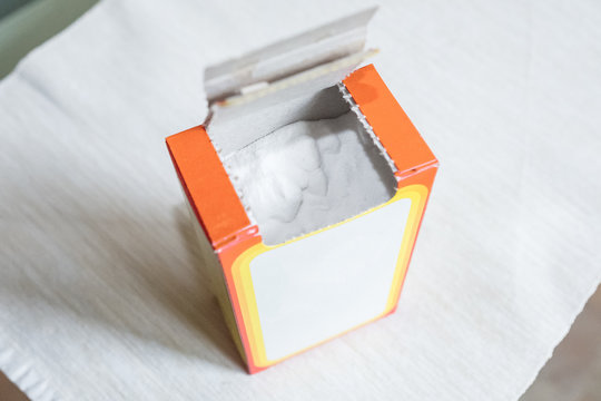 Baking soda in a paper box. Packaging of soda in the kitchen