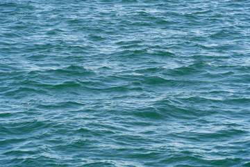 Blue water background. Waves on water surface, watery texture