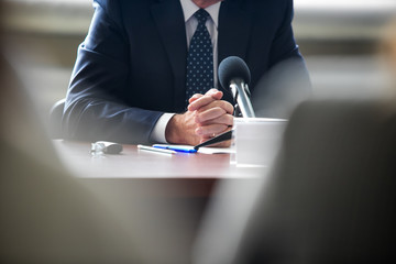 Press conference. Public speaker giving talk to Television camera. News conference. An event with a...