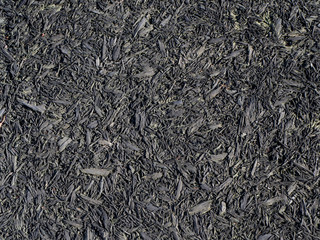 Soft dark rubber bark playground mulch texture floor background