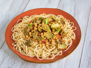 Chickpeas curry noodles on white wooden background.