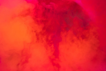 Paints dissolved in water with a beautiful spectacular blur. Trending neon orange colors. Bright amazing abstract background. Smoke effect..