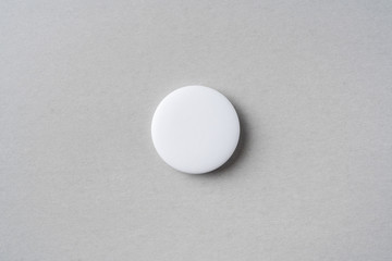 top view of white badge on grey background