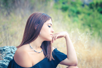 A beautiful girl thinking about something in the country