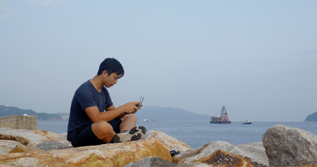 Man control a drone at seaside