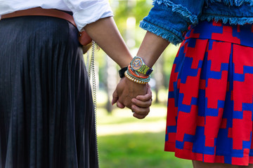 Young women are having fun on the green park in the evening.