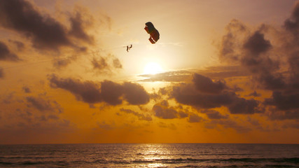 Parasailing in the sunset sky, Patong beach, Phuket, Thailand