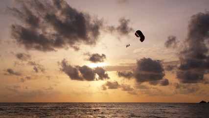 Parasailing in the sunset sky, Patong beach, Phuket, Thailand