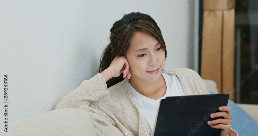 Wall mural woman watch on tablet computer