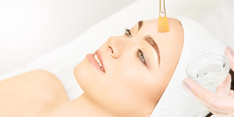 Facial brush peel retinol treatment. Beauty woman peeling procedure. Cosmetology young girl...