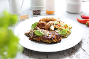 Lentil cutlet with mushrooms served with cucumber salad and potatoes