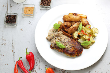 Lentil cutlet with mushrooms served with cucumber salad and potatoes