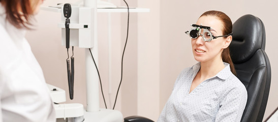 Eye ophthalmologist exam. Eyesight recovery. Astigmatism check concept. Ophthalmology diagmostic device. Beauty girl portrait in clinic - obrazy, fototapety, plakaty