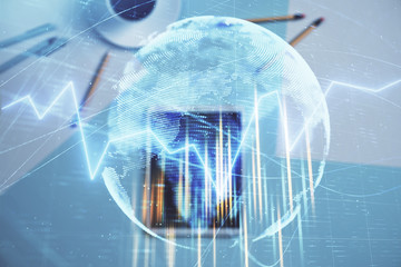 Double exposure of forex chart and world map on digital tablet laying on table background. Concept of market analysis