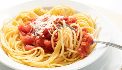 close up on dish with spaghetti tomato and basil