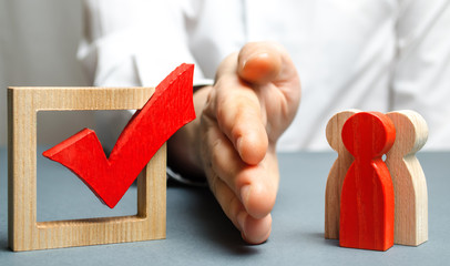 A man separate a group of people with a palm and a red check mark for voting. concept of preventing...