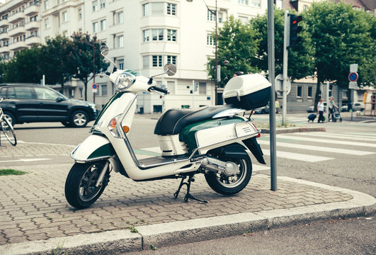 PARIS, FRANCE - JUN 27, 2015: Side view of Piaggio scooter parked on a French street