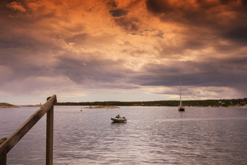 Boat on the lake over sundown twilight sky background