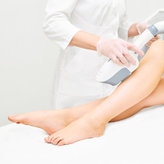 Laser ipl device in doctor hand. Woman body hair removal. Perfect epilator. Cosmetology leg technology