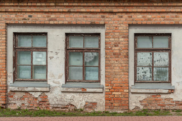 background of windows in an old abandoned brick building close up