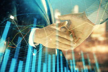 Double exposure of financial chart on cityscape background with two businessmen handshake. Concept of financial analysis and investment opportunities