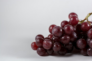 glass of pomegranate juice and cherries isolated on white background