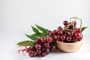 glass of pomegranate juice and cherries isolated on white background
