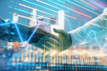 Double exposure of financial chart on cityscape background with two businessmen handshake. Concept of financial analysis and investment opportunities