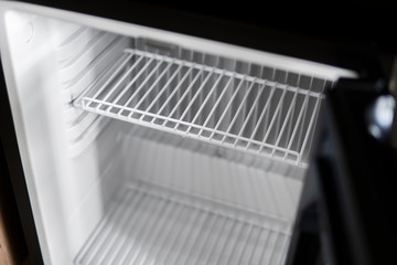 Empty open fridge with shelves, refrigerator. Empty cooler.