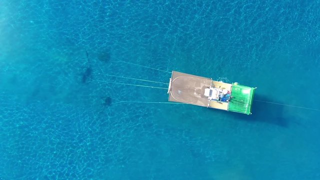 Aerial zenith view of a Shrimp boat in the Mediterranean, in front of the coast of Malaga. Picking the typical "concha fina" Malaga&rsquo;s clam (Cytherea chione). 