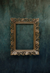 Metal golden frame on a wall
