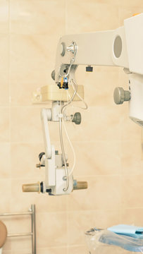 Ophthalmology laser microscope operation. Clinic room with doctor and parient. Gloves and medicine tools. Defocused