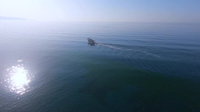 Aerial view of a Shrimp boat in the Mediterranean, in front of the coast of Malaga. Picking the typical "concha fina" Malaga&rsquo;s clam (Cytherea chione)