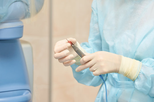 Ophthalmology laser microscope operation. Clinic room with doctor and parient. Gloves and medicine tools