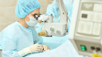 Ophthalmology laser microscope operation. Doctor in clinic. Patient eye treatment. Myopia and...