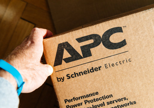PARIS, FRANCE - MAR 29, 2018: man holding hand near the logo of APC Smart-UPS C enterprise-level uninterruptible power supplies made by American Power Conversion Schneider Electric