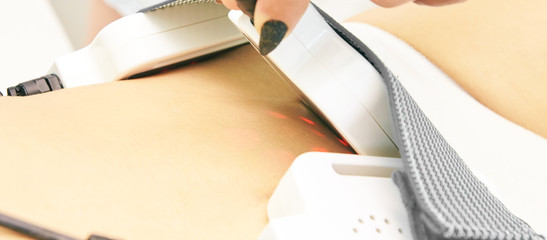 Laser lipo equipment. Cosmetic fat reduce treatment. Woman in medicine salon. Anti cellulite procedure