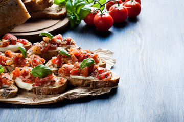 Italian bruschetta with roasted tomatoes, mozzarella cheese and