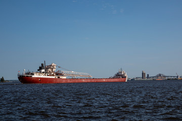 Fototapeta premium A Ship In Harbor Traveling To Dock