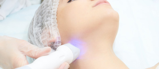 Dermatology skin care facial therapy. Medical spa anto wrinkles procedure. Woman face rejuvenation. Pretty girl. Rf cosmetician equipment. Chin and neck