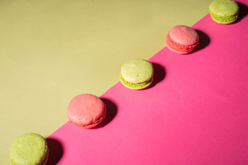 cookies in the form of multi-colored hamburgers. On a pink cardboard background. Minimal concept