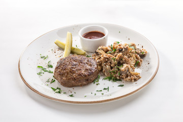 Meat patties with tomato sauce and cooked buckwheat with mushroom isolated on white background