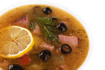 soup with meat, olives, lemon, seasonings and spices. isolated Russian Solyanka