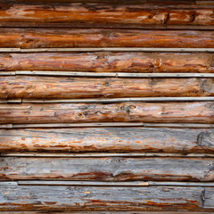 Roundish Rustic Log Wall Horizontal Timber Background. Planed Wood. Natural texture part facade of a log wall of cabin or house.